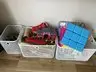 Boxes of toys, a wooden train set and foam blocks
